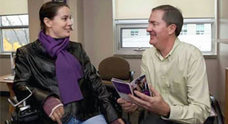 Two people looking at book